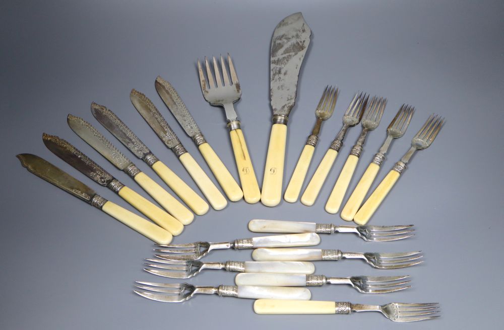 A pair of Edwardian silver ivory handled fish servers by Mappin & Webb, six pairs of ivory handled silver dessert eaters, etc.
